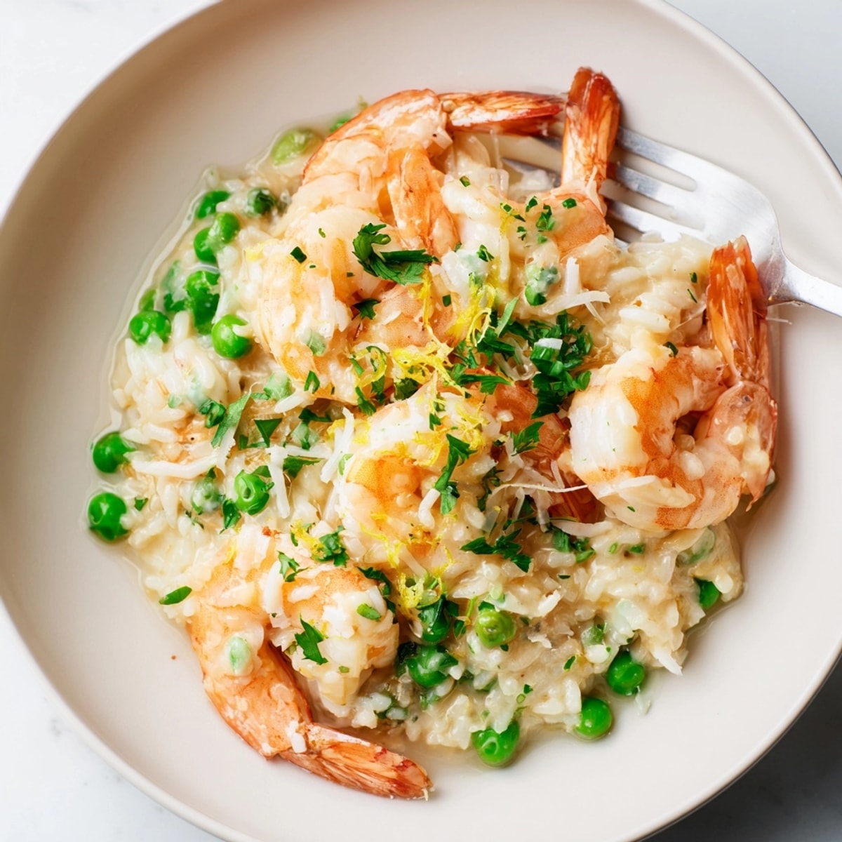 A skillet of Shrimp Parmesan Rice, ready to serve, topped with extra cheese.