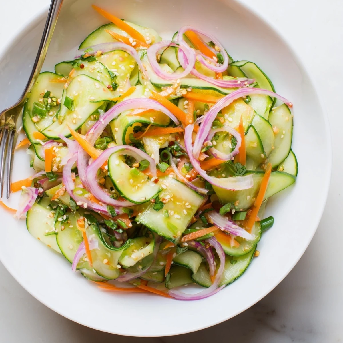 Fresh cucumber salad remix drizzled with tangy sesame oil and fish sauce.  