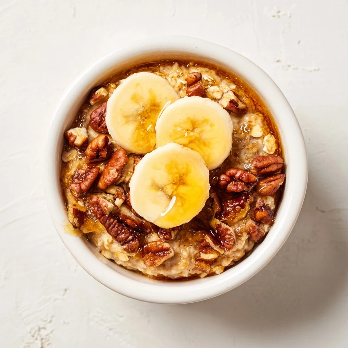 Golden-brown Baked Oats Ramekins with banana slices and a lovely honey drizzle.