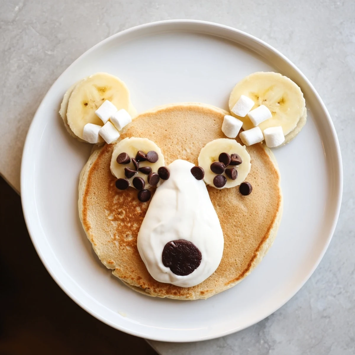 Fluffy Polar Bear Pancake Stack Board with fresh berries and chocolate hazelnut spread, delicious brunch ideal for kids.