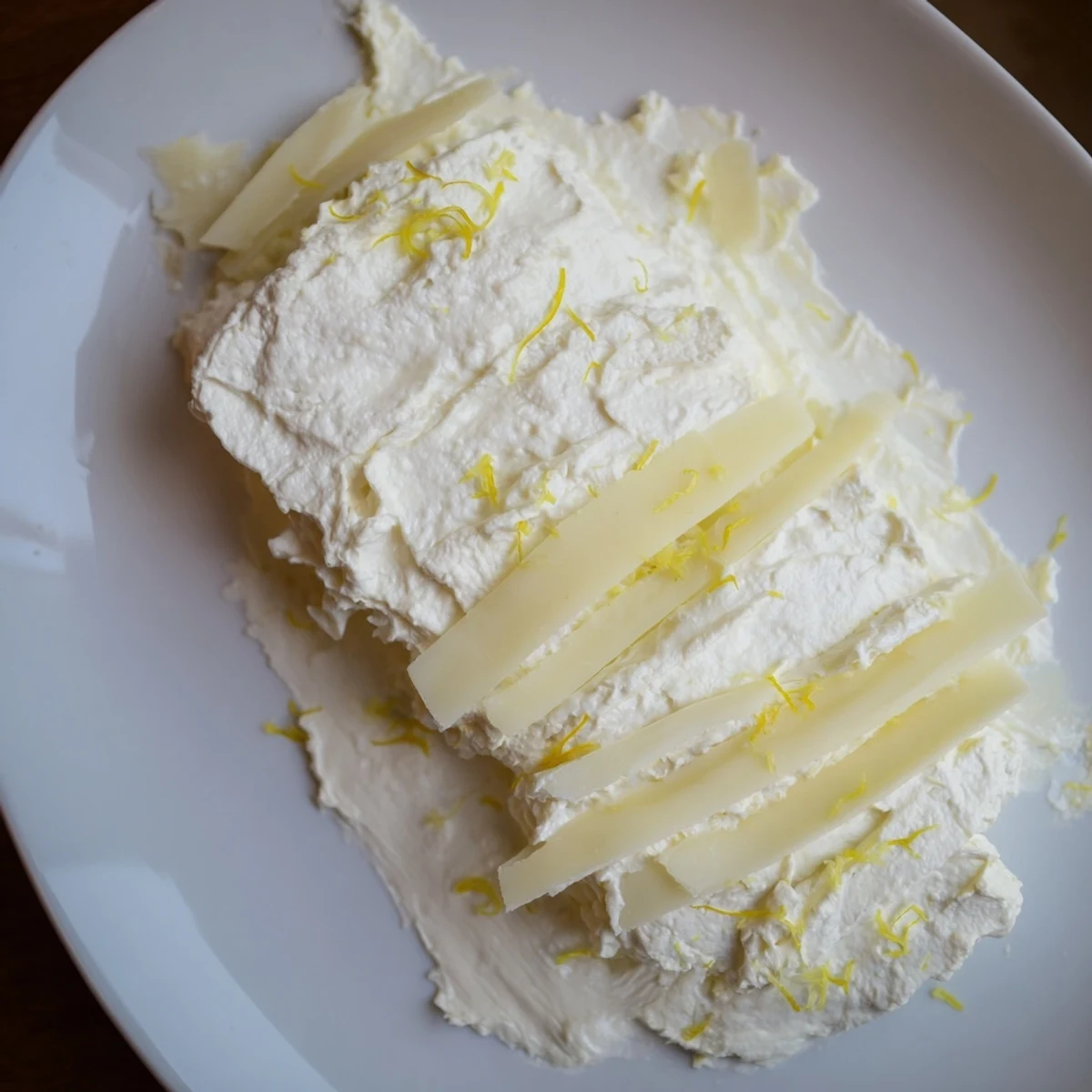 Elegant The Saffron Silk cheese board: creamy saffron ricotta and ribbons of colorful cheeses, ready to serve.