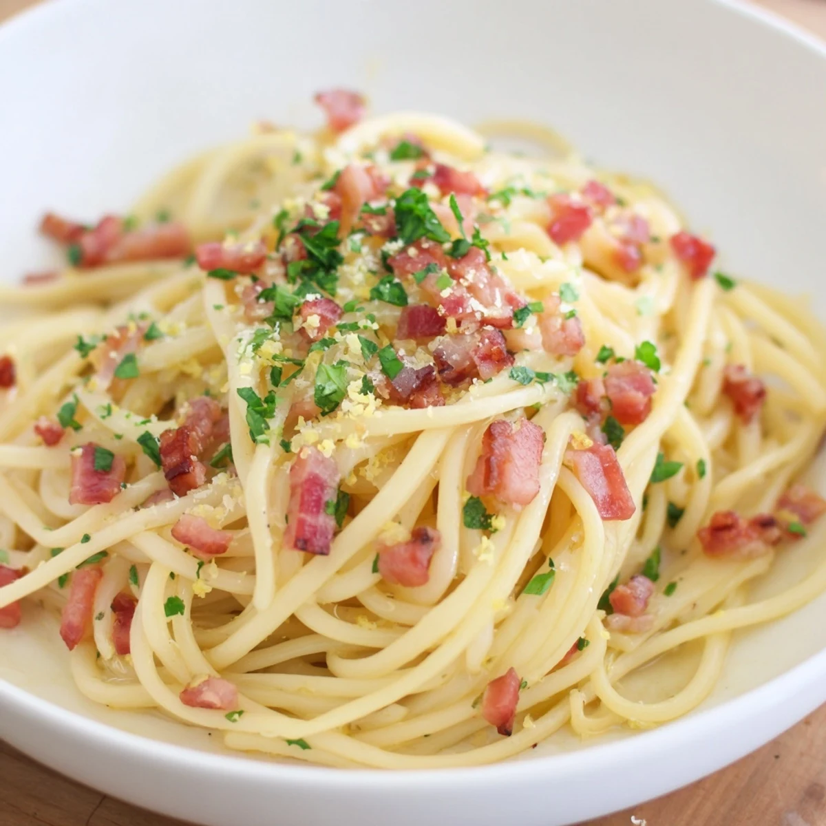 Golden, crispy bacon tops this delicious Crispy Bacon Linguine with parsley garnish, ready to enjoy.