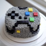 A visually striking Pixel Video Game Controller Cake, ideal for a gamer, features precisely designed pixelated buttons.