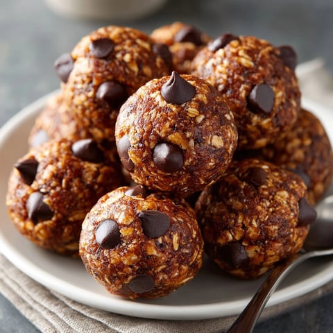 Chocolate Protein Energy Bites arranged on a parchment-lined tray, perfect for an easy healthy snack.