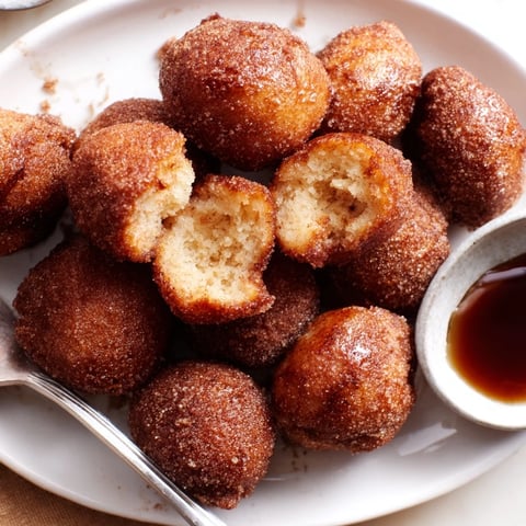 Fluffy Maple Bourbon Cinnamon Pancake Balls topped with sweet maple syrup and warm spices.  