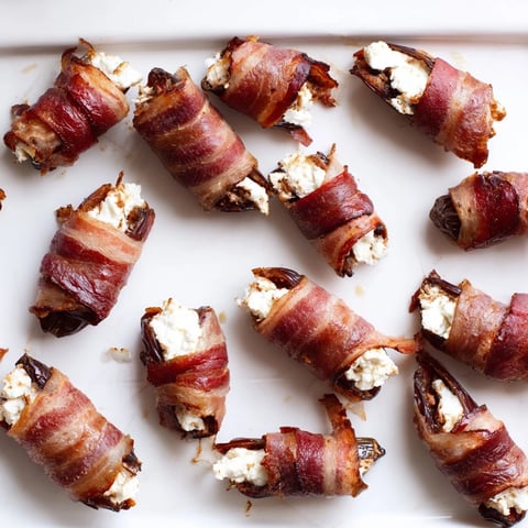 Crispy bacon-wrapped dates stuffed with creamy goat cheese, an irresistible appetizer ready to enjoy.