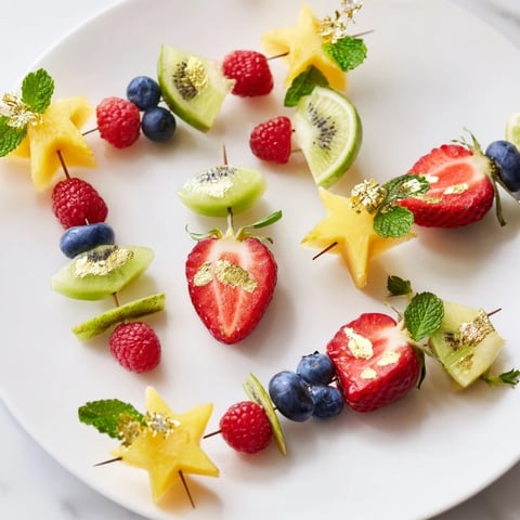 Elegant Champagne Flute Fruit Garnishes: Colorful fruit skewers adorn a flute, perfect for New Year's.