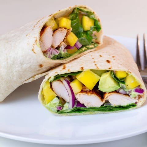 Stacked Mango Avocado Chicken Wraps, a vibrant tropical lunch, ready to be enjoyed.