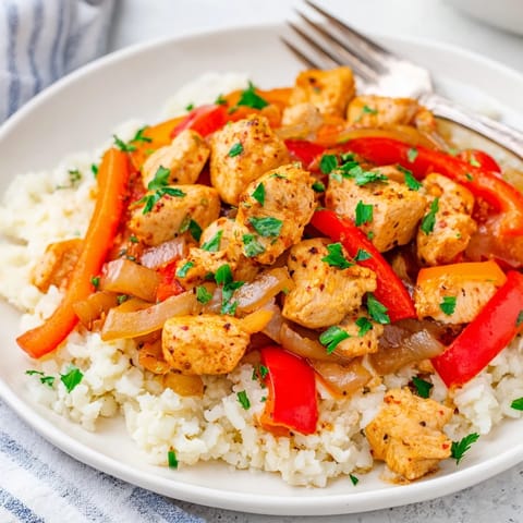 Flavor-packed Cajun Chicken Skillet Stir-Fry garnished with fresh parsley and lime zest.  