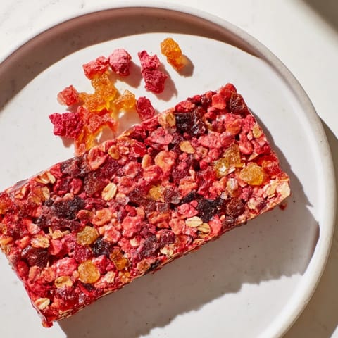 Delicious homemade gummies infused with fruit juice atop a wholesome oat snack bar.  