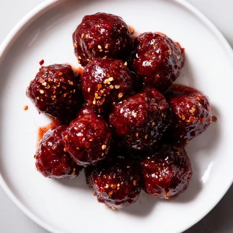 Warm, glazed cherry meatballs offer a delicious sweet and tangy flavor, perfect for sharing.