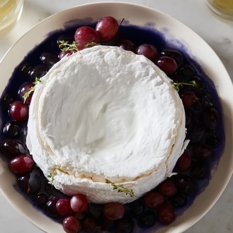 A decadent "Floating Island" appetizer: a cheese "island" afloat a sea of vibrant blue dip.