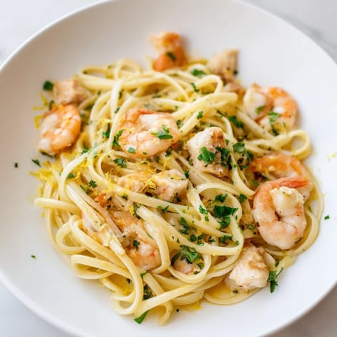 Tender chicken and succulent shrimp tossed with linguine in a vibrant lemon garlic butter sauce.