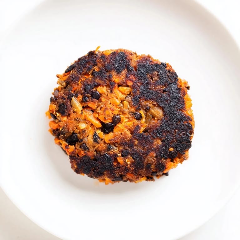 Stack of savory black bean burgers, served with vibrant toppings, offer a delicious vegan grilling option.