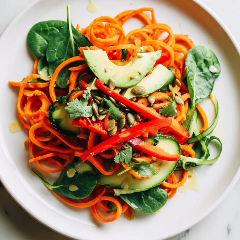 Healthy Vegan Carrot Noodle Skincare Bowl featuring bright colors, fresh ingredients, and flavorful sauce.