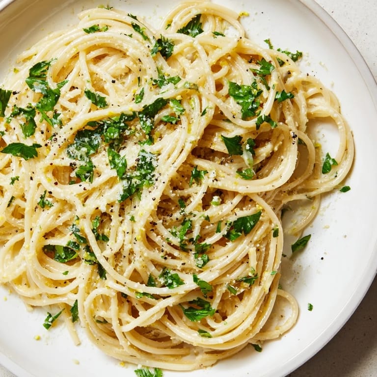 Steaming bowl of Lemon Butter Pasta Light, glistening with Parmesan, ready for a delicious, light dinner.