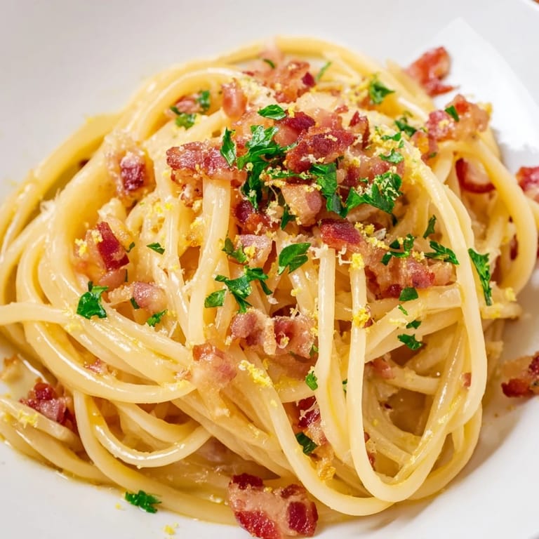 A steaming plate of Crispy Bacon Linguine showcases perfectly cooked pasta and savory, rich bacon.