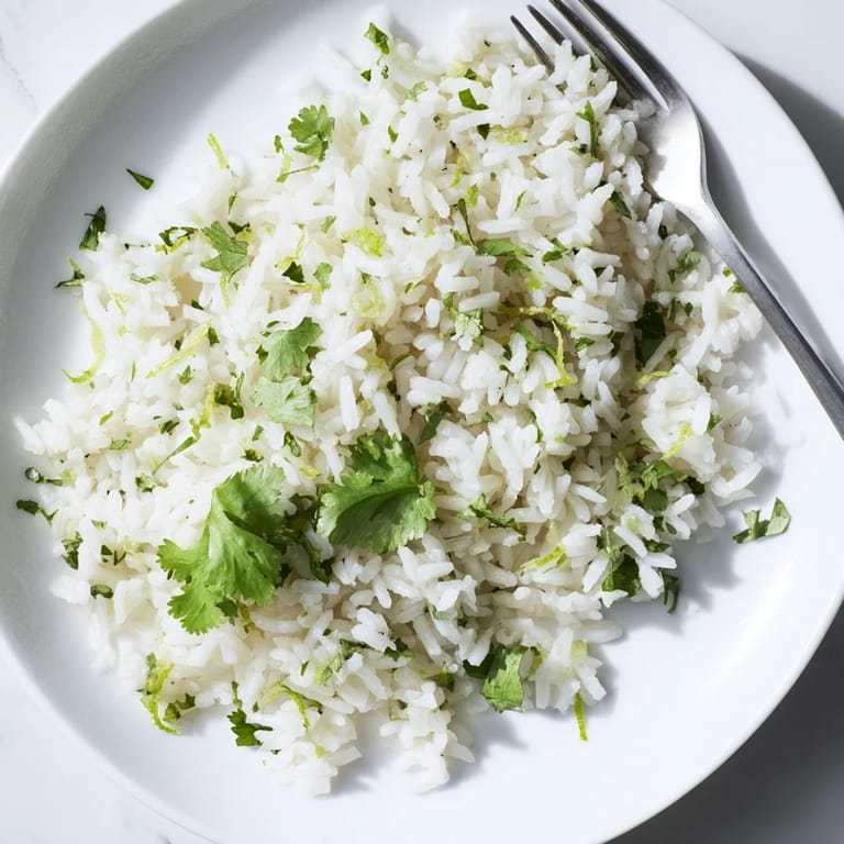 Zesty cilantro lime rice garnished with lime wedges, a fragrant vegan side perfect for weeknight Mexican-inspired dinners.