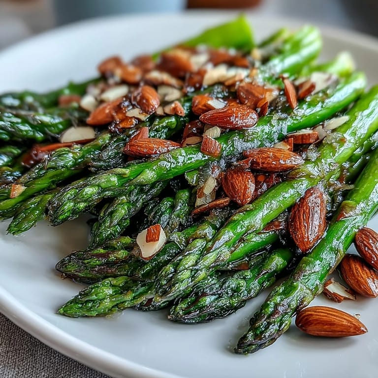 Lemon butter asparagus with toasted almonds, a vibrant spring side dish with crisp-tender vegetables and crunchy nut garnish.